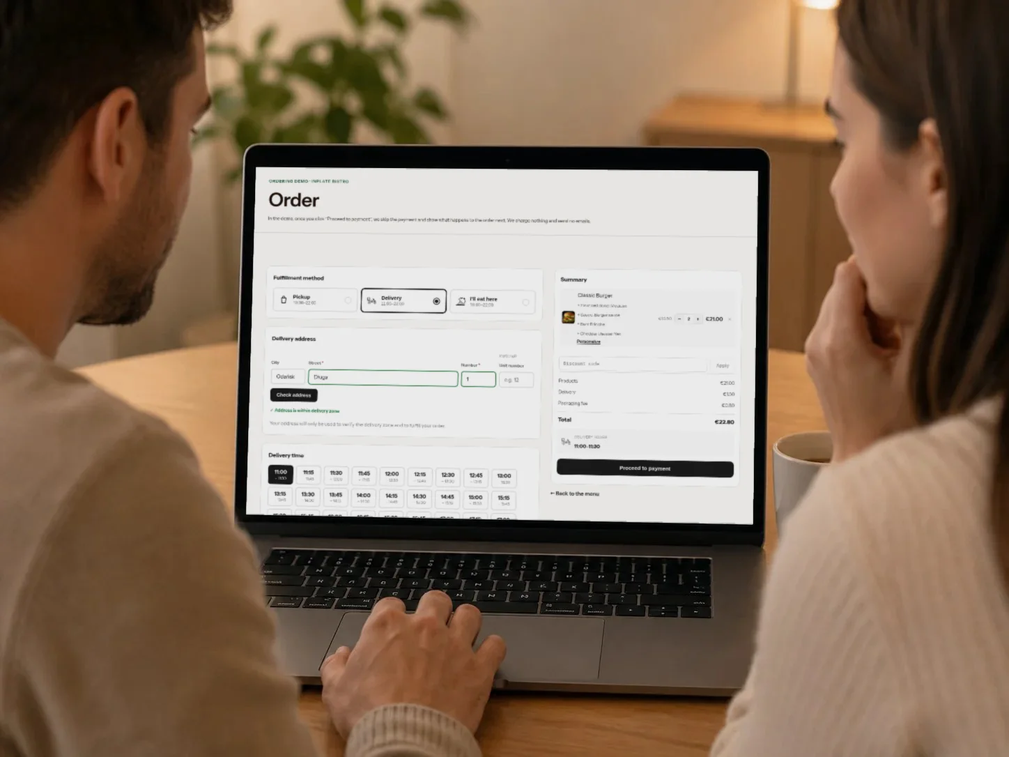 A couple placing an order online on a laptop